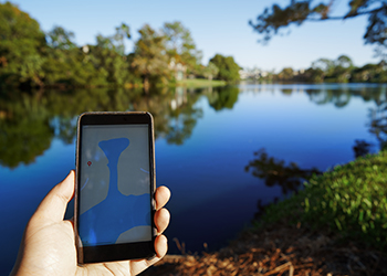 A person holds a phone showing a map 