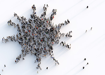 Multiple people shot from above forming the shape of a virus