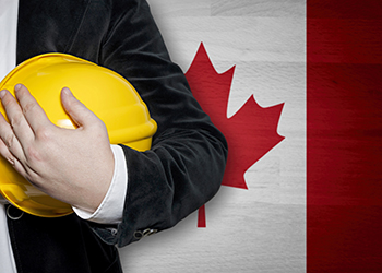 Construction worker in front of Canadian flag
