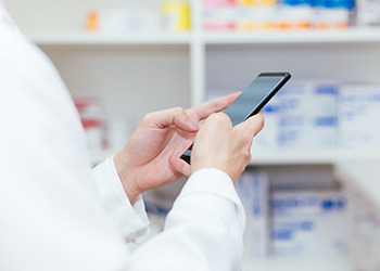 A pharmacist texting