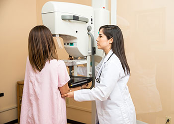 A woman having a breast screening exam
