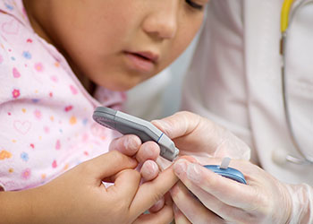 A girl testing her glucose level