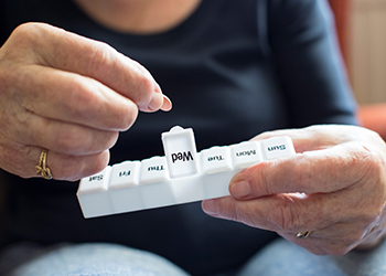 A woman with a pill dispenser