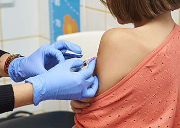 A young girl being vacinated