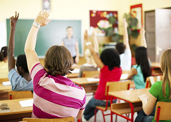 Children sitting at desks in a classroom