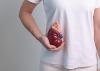 A woman holds a model of a kidney