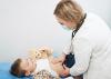 A young boy undergoing an abdominal exam