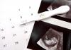 A calendar, a positive pregnancy test and an ultrasound photograph