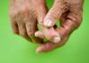 A close up of an older person massaging their fingers