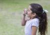 A young girl using an inhaler