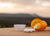 A bottle of pills on a table outside