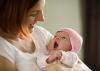 A mother holds her newborn baby